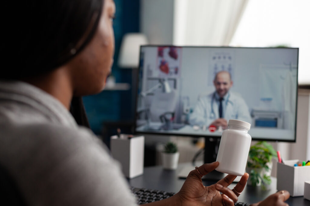 Woman with chronic disease using video call on monitor for telehealth